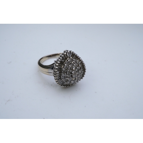 275 - A diamond dress ring designed as a pear-shaped cluster of brilliant-cut diamonds within a border of ... 