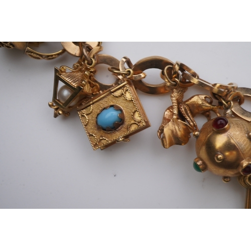 277 - A gold charm bracelet the gold bracelet composed of oval and X-shaped links, suspending a series of ... 