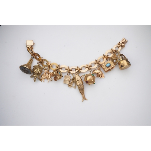 277 - A gold charm bracelet the gold bracelet composed of oval and X-shaped links, suspending a series of ... 