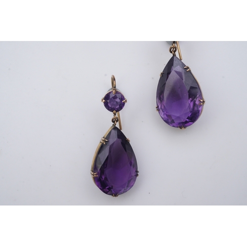 278 - A pair of amethyst earrings, early 20th century, each composed of a circular-cut amethyst suspending... 