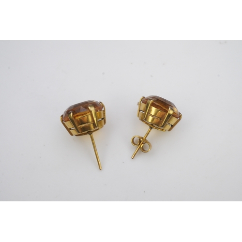 279 - A pair of citrine ear studs, each set with a circular step-cut citrine, 1.3cm diameter each, post fi... 