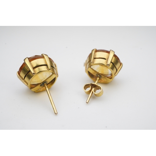 279 - A pair of citrine ear studs, each set with a circular step-cut citrine, 1.3cm diameter each, post fi... 