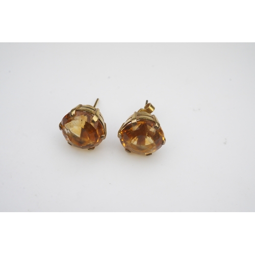 279 - A pair of citrine ear studs, each set with a circular step-cut citrine, 1.3cm diameter each, post fi... 