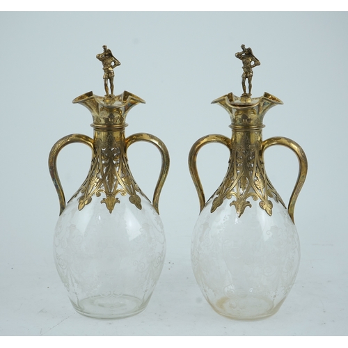 28 - A good pair of Victorian silver gilt mounted wheel engraved glass two handled decanters and stoppers... 