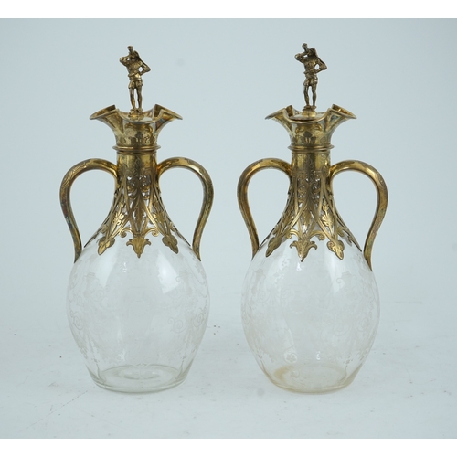 28 - A good pair of Victorian silver gilt mounted wheel engraved glass two handled decanters and stoppers... 