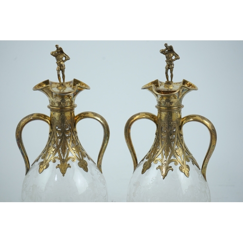 28 - A good pair of Victorian silver gilt mounted wheel engraved glass two handled decanters and stoppers... 