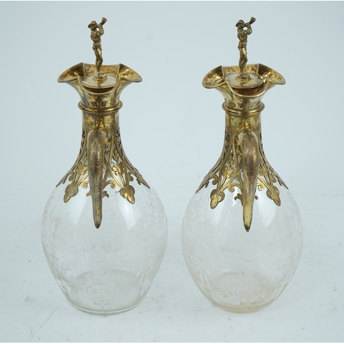 28 - A good pair of Victorian silver gilt mounted wheel engraved glass two handled decanters and stoppers... 