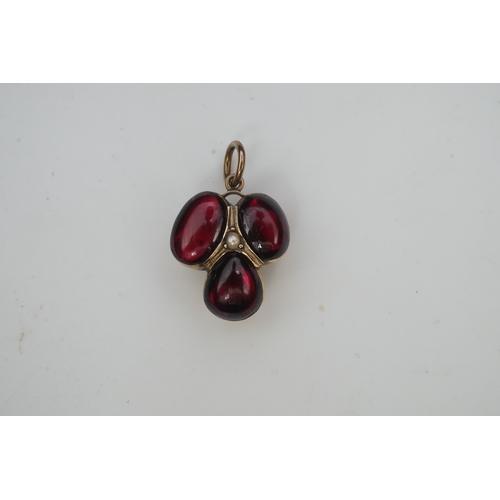 281 - A Victorian garnet locket pendant, mid 19th century, set with three cabochon garnets in foiled setti... 