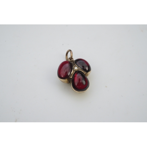 281 - A Victorian garnet locket pendant, mid 19th century, set with three cabochon garnets in foiled setti... 