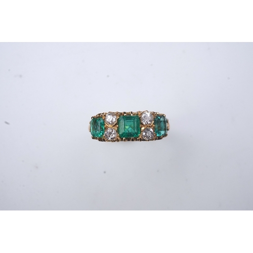 282 - A late Victorian emerald and diamond ring, circa 1901, set with three step-cut emeralds totalling ap... 