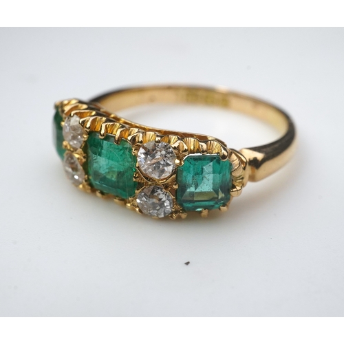 282 - A late Victorian emerald and diamond ring, circa 1901, set with three step-cut emeralds totalling ap... 