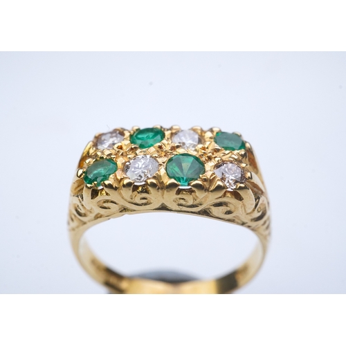 283 - An emerald and diamond ring, circa 1975, designed in the Victorian style, set with two lines of bril... 