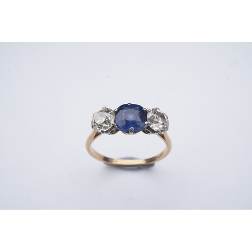 287 - A sapphire and diamond three-stone ring, early 20th century, claw-set with a cushion-shaped sapphire... 