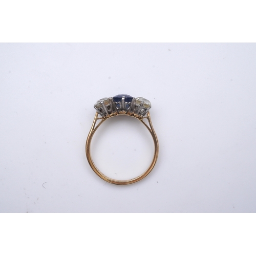 287 - A sapphire and diamond three-stone ring, early 20th century, claw-set with a cushion-shaped sapphire... 