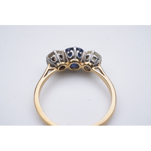 287 - A sapphire and diamond three-stone ring, early 20th century, claw-set with a cushion-shaped sapphire... 