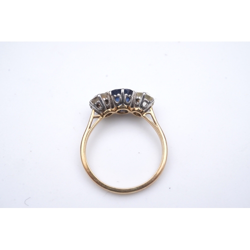 287 - A sapphire and diamond three-stone ring, early 20th century, claw-set with a cushion-shaped sapphire... 