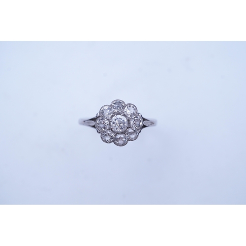 291 - A diamond ring, circa 1920, designed as a floral cluster of circular-cut diamonds totalling approxim... 