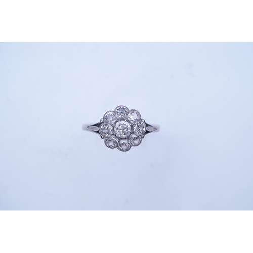 291 - A diamond ring, circa 1920, designed as a floral cluster of circular-cut diamonds totalling approxim... 