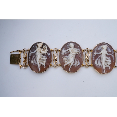 299 - A shell cameo bracelet, Italy, set with five oval shells carved with muses, mounted in 14ct gold, le... 