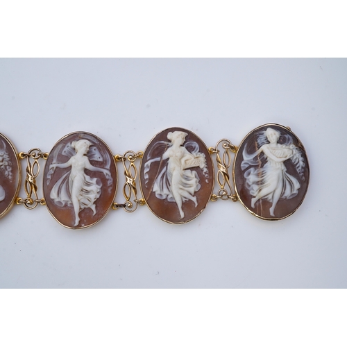 299 - A shell cameo bracelet, Italy, set with five oval shells carved with muses, mounted in 14ct gold, le... 