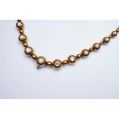 300 - An unusual Victorian gold and diamond necklace, late 19th century, composed of spherical gold beads,... 