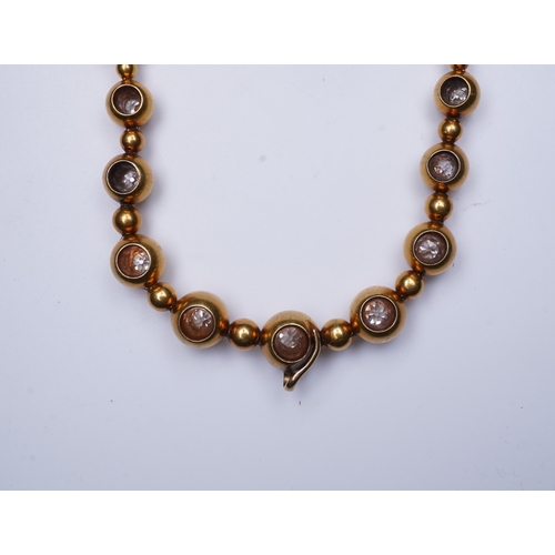 300 - An unusual Victorian gold and diamond necklace, late 19th century, composed of spherical gold beads,... 