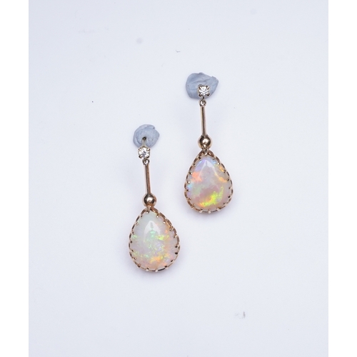 303 - A pair of opal and diamond earrings, each composed of a pear-shaped cabochon opal suspended by a kni... 