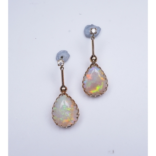 303 - A pair of opal and diamond earrings, each composed of a pear-shaped cabochon opal suspended by a kni... 