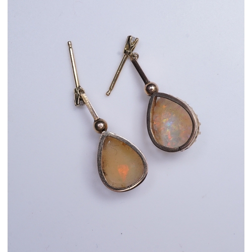 303 - A pair of opal and diamond earrings, each composed of a pear-shaped cabochon opal suspended by a kni... 