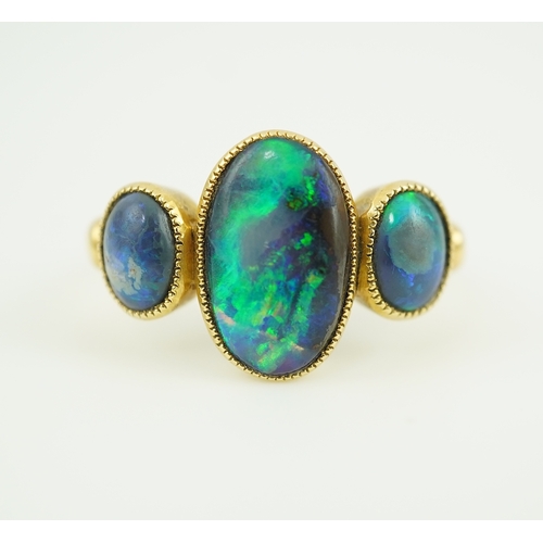 304 - A Victorian black opal ring, circa 1881, set with three cabochon black opals, mounted in 18ct gold, ... 