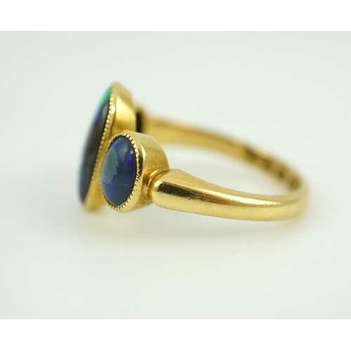 304 - A Victorian black opal ring, circa 1881, set with three cabochon black opals, mounted in 18ct gold, ... 