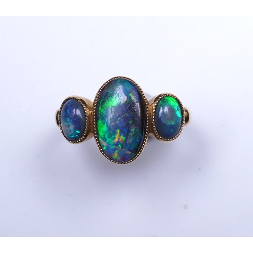 304 - A Victorian black opal ring, circa 1881, set with three cabochon black opals, mounted in 18ct gold, ... 