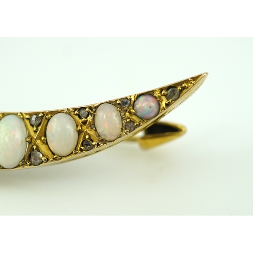 306 - An opal and diamond brooch, early 20th century, designed as a crescent moon, set with opal cabochons... 