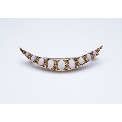 306 - An opal and diamond brooch, early 20th century, designed as a crescent moon, set with opal cabochons... 