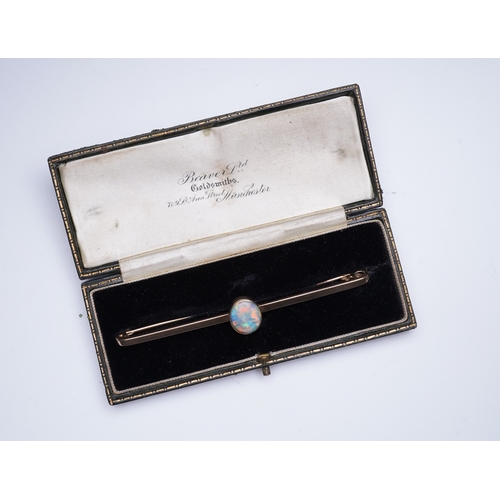 307 - An Edwardian gold and opal brooch, early 20th century, centring on a cabochon opal measuring approxi... 