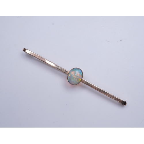 307 - An Edwardian gold and opal brooch, early 20th century, centring on a cabochon opal measuring approxi... 