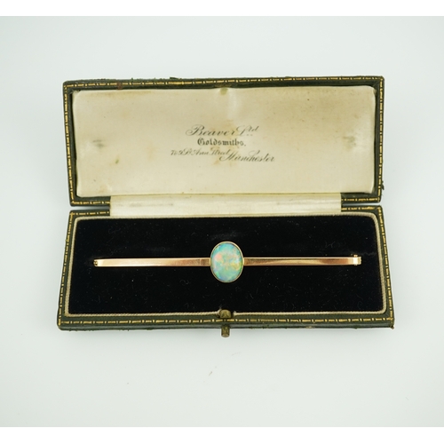 307 - An Edwardian gold and opal brooch, early 20th century, centring on a cabochon opal measuring approxi... 