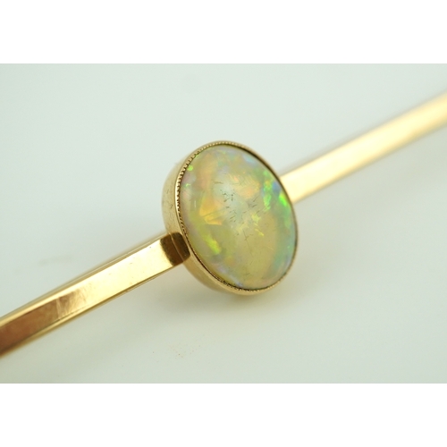 307 - An Edwardian gold and opal brooch, early 20th century, centring on a cabochon opal measuring approxi... 