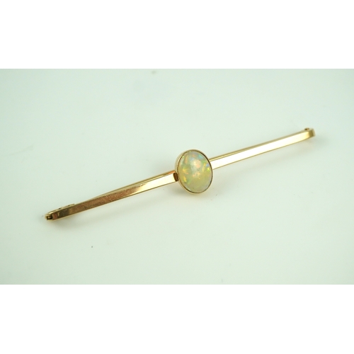 307 - An Edwardian gold and opal brooch, early 20th century, centring on a cabochon opal measuring approxi... 