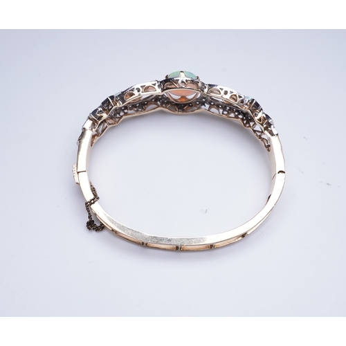 308 - An opal and diamond bangle, of hinged design, the front set with cabochon and heart-shaped opals wit... 