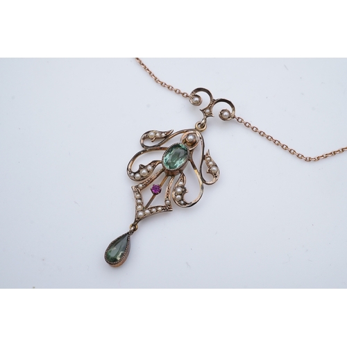 309 - An Edwardian gem-set pendant, early 20th century, of foliate scroll design, set with oval and pear-s... 