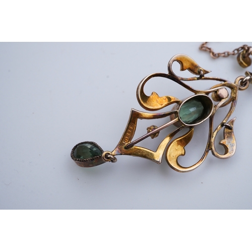 309 - An Edwardian gem-set pendant, early 20th century, of foliate scroll design, set with oval and pear-s... 