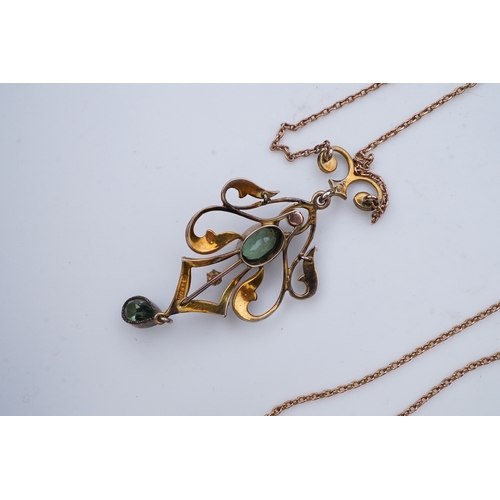 309 - An Edwardian gem-set pendant, early 20th century, of foliate scroll design, set with oval and pear-s... 