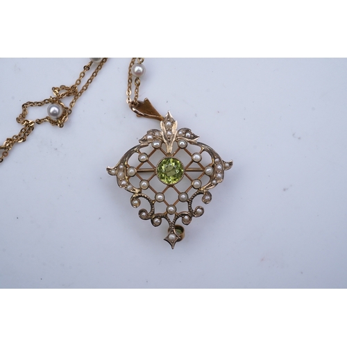 311 - An Edwardian peridot and seed pearl pendant/brooch, early 20th century, of foliate openwork design, ... 