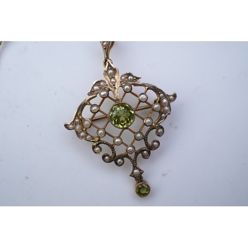 311 - An Edwardian peridot and seed pearl pendant/brooch, early 20th century, of foliate openwork design, ... 