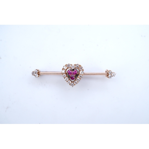 312 - An Edwardian ruby and diamond brooch, centring on a heart motif set with cushion-shaped rubies and c... 