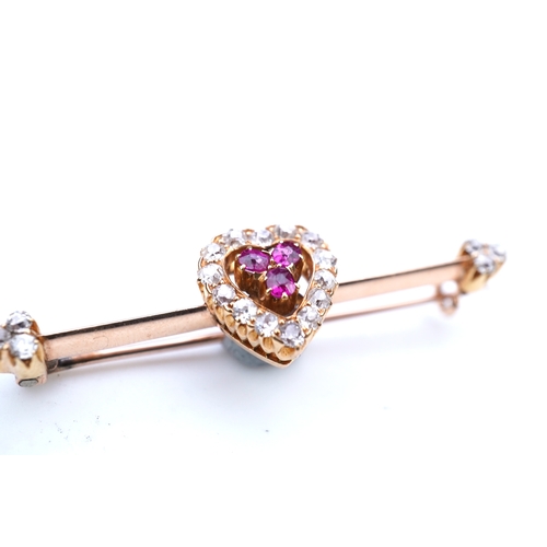 312 - An Edwardian ruby and diamond brooch, centring on a heart motif set with cushion-shaped rubies and c... 