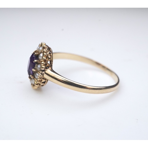 313 - An Edwardian amethyst and seed pearl ring, early 20th century, of cluster design, set with an oval a... 