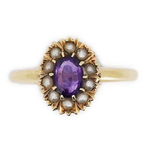 313 - An Edwardian amethyst and seed pearl ring, early 20th century, of cluster design, set with an oval a... 