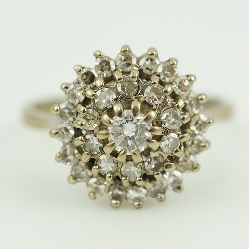 317 - A diamond ring, of cluster design, set with a brilliant-cut diamond within two concentric bands of s... 